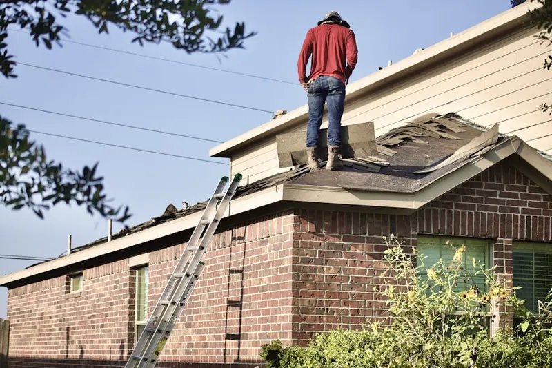 Professional roofer working on a residential roof in Clarksburg